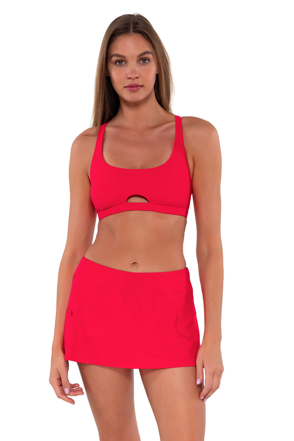 Front pose #1 of Daria wearing Sunsets Geranium Sporty Swim Skirt with matching Brandi Bralette bikini top