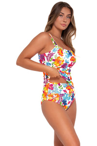 Side pose #1 of Taylor wearing Sunsets Camilla Flora Taylor Tankini Top lifted to show matching Hannah High Waist