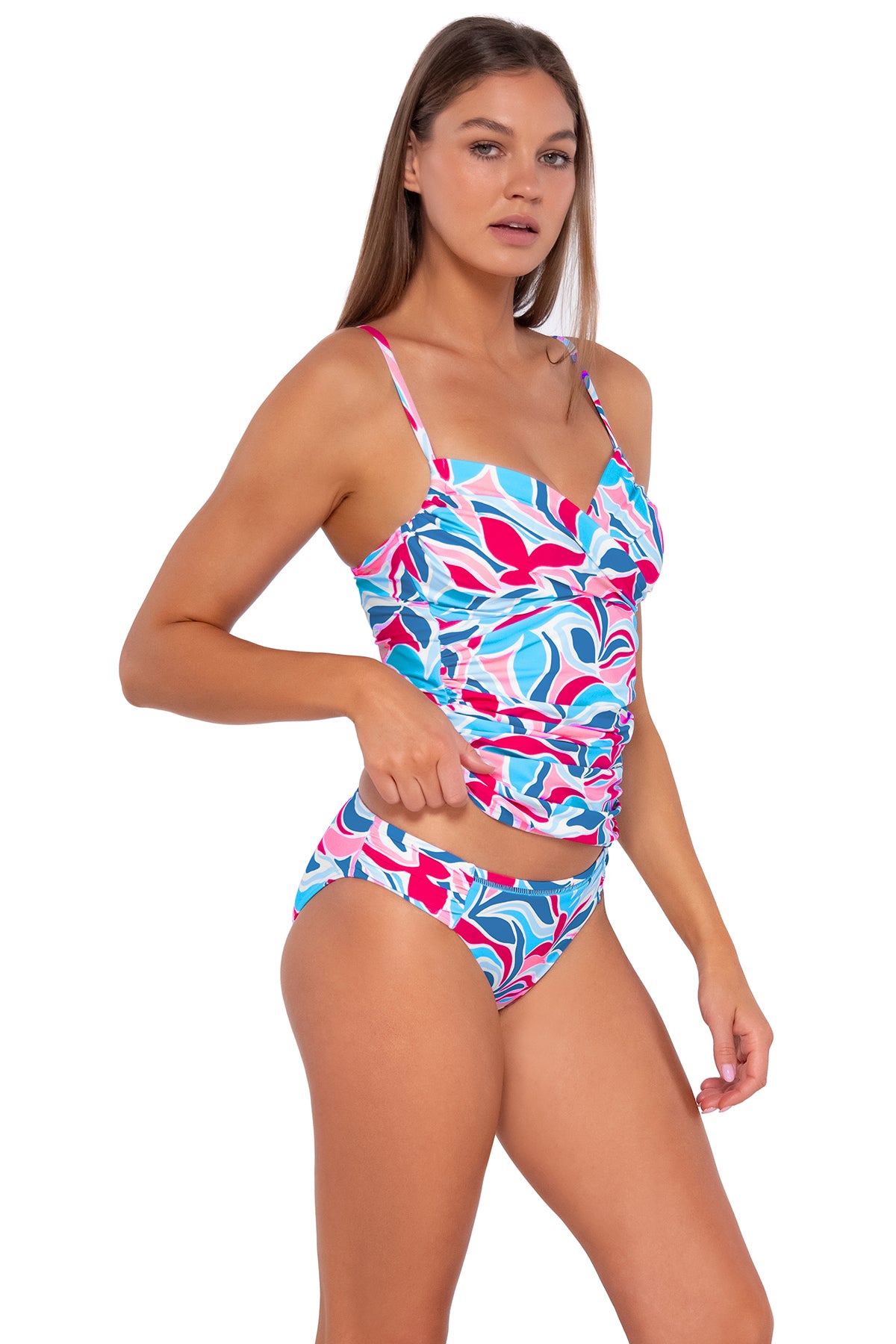 Side pose #1 of Daria wearing Sunsets Making Waves Simone Tankini Top lifted to show matching Audra Hipster bikini bottom