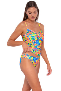 Side pose #1 of Daria wearing Sunsets Shoreline Petals Simone Tankini Top lifted to show matching Audra Hipster bikini bottom