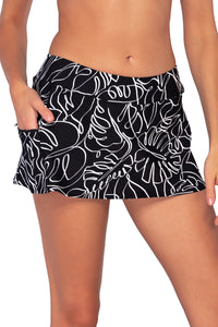 Front view of Sunsets Lost Palms Sporty Swim Skirt with hand in pocket