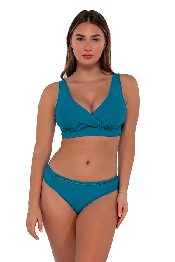 Front pose #1 of Taylor wearing Sunsets Avalon Teal Audra Hipster Bottom paired with Elsie Top bikini bralette