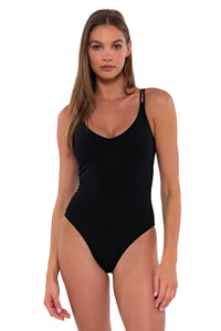 Front pose #2 of Daria wearing Sunsets Black Veronica One Piece