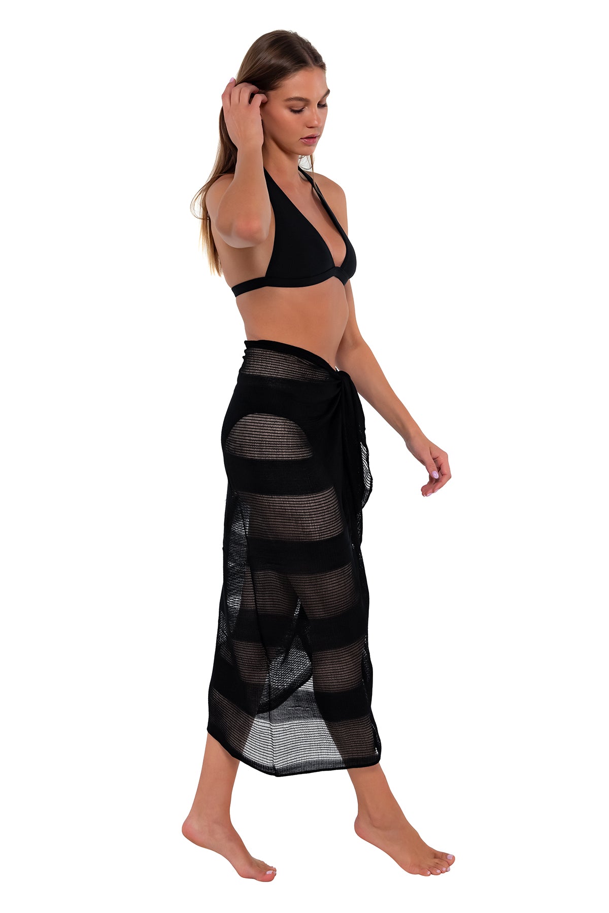 Side pose #1 of Daria wearing Sunsets Black Paradise Pareo with matching Faith Halter bikini top