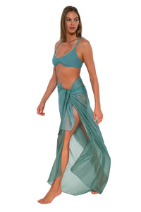 Side pose #1 of Daria wearing Sunsets Ocean Paradise Pareo with matching Brooke U-Wire bikini top