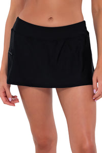Front pose #1 of Daria wearing Sunsets Black Sporty Swim Skirt