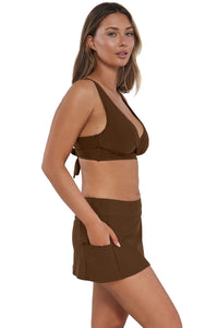 Quarter pose #1 of Taylor wearing Sunsets Tiki Brown Sporty Swim Skirt with hand in pocket