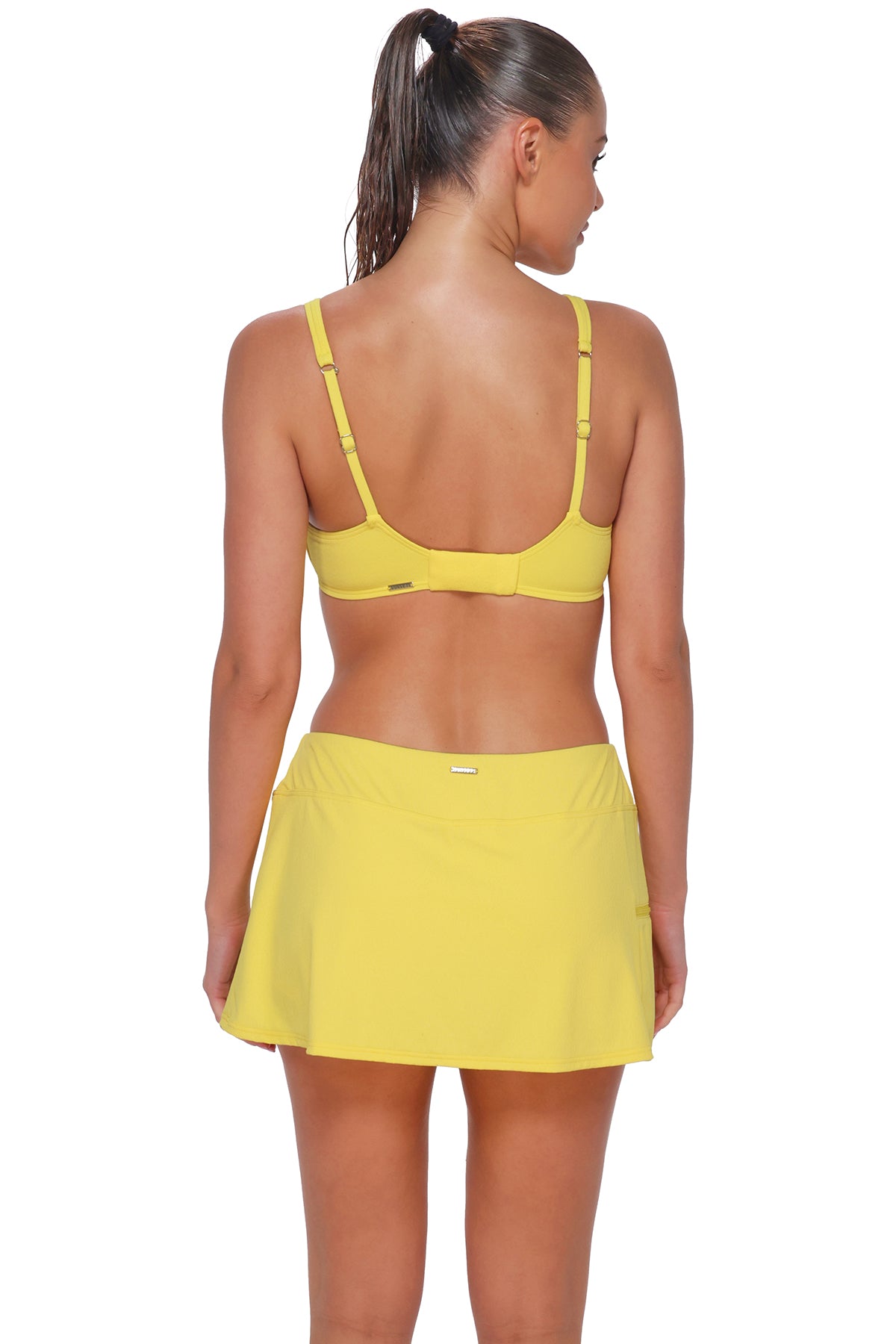 Back pose #1 of Daniella wearing Sunsets Pineapple Crepe Sporty Swim Skirt