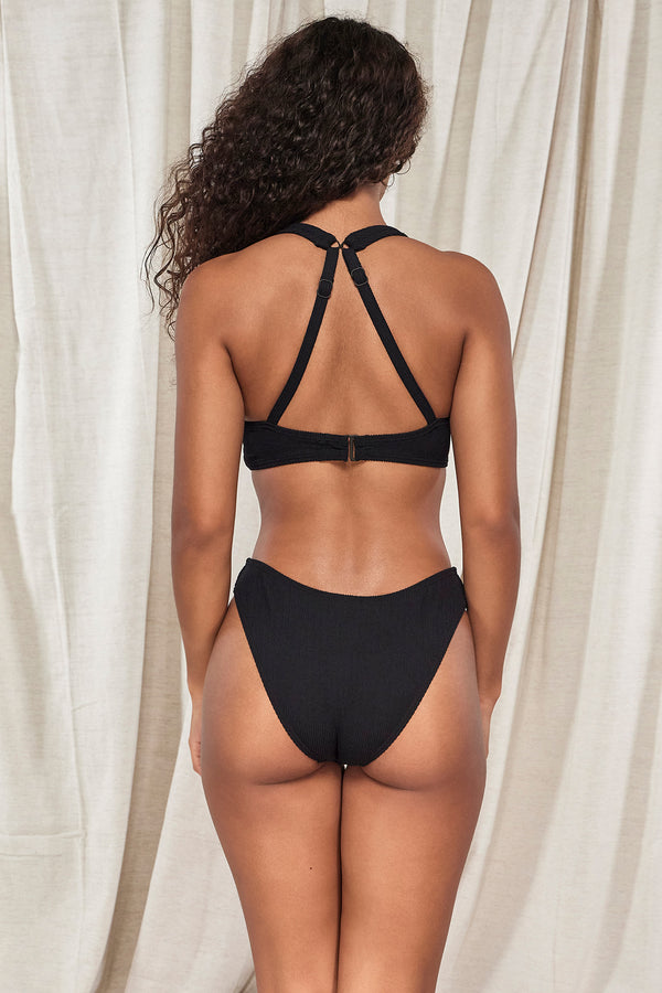 Back pose #1 of Jasmine wearing Pacifica Black Mirabella Top showing crossback straps paired with matching Sandy Scoop Bikini Bottom