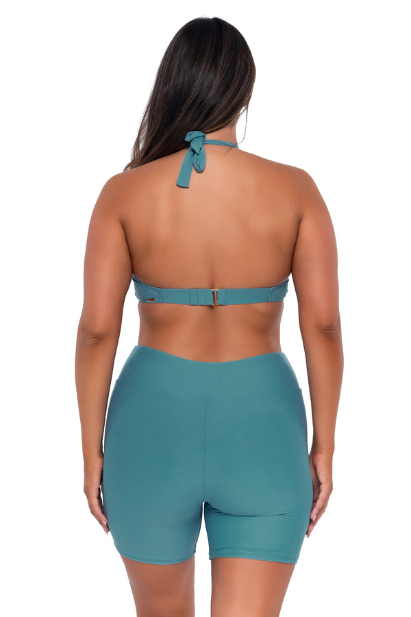 Back pose #1 of Nicky wearing Sunsets Escape Ocean Bayside Bike Short with matching Muse Halter bikini top