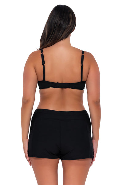 Back pose #1 of Nicky wearing Sunsets Escape Black Laguna Swim Short with matching Crossroads Underwire bikini top