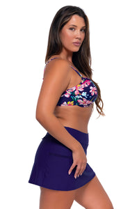 Side pose #1 of Nicky wearing Sunsets Island Getaway Crossroads Underwire Top with matching Sporty Swim Skirt