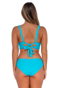 Back pose #1 of Taylor wearing Sunsets Blue Bliss Alana Reversible Hipster Bottom with matching Elsie Top underwire bikini