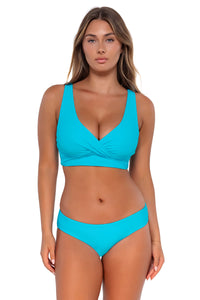 Front pose #1 of Taylor wearing Sunsets Blue Bliss Alana Reversible Hipster Bottom with matching Elsie Top underwire bikini