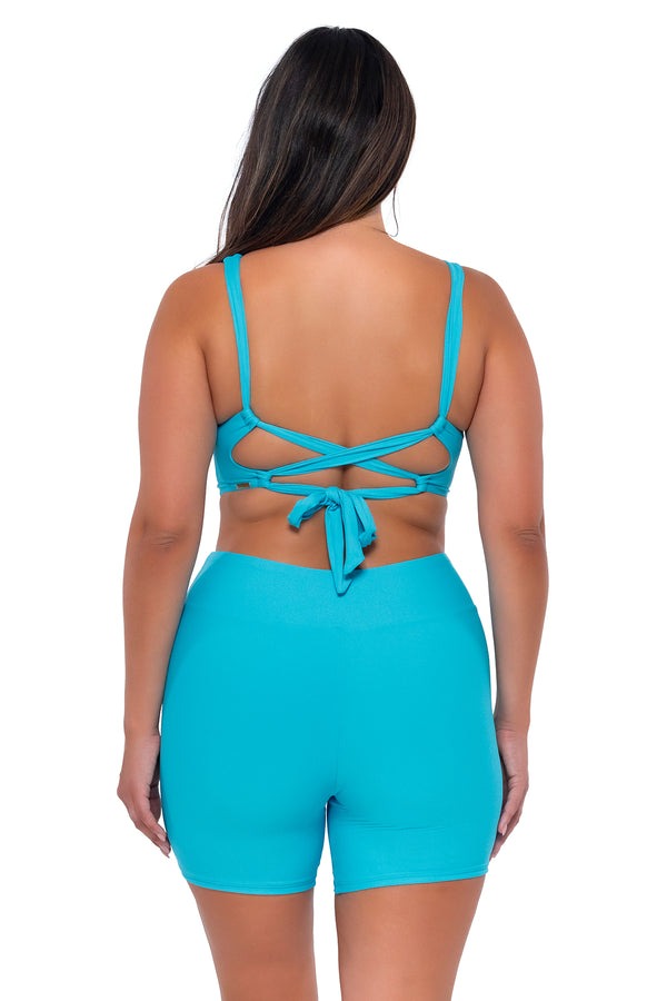 Back pose #1 of Nicky wearing Sunsets Escape Blue Bliss Bayside Bike Short with matching Elsie Top underwire bikini