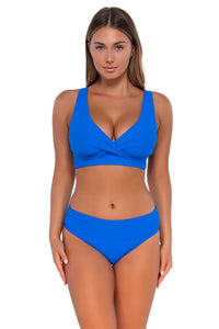Front pose #1 of Taylor wearing Sunsets Electric Blue Hannah High Waist Bottom showing folded waist with matching Elsie Top underwire bikini
