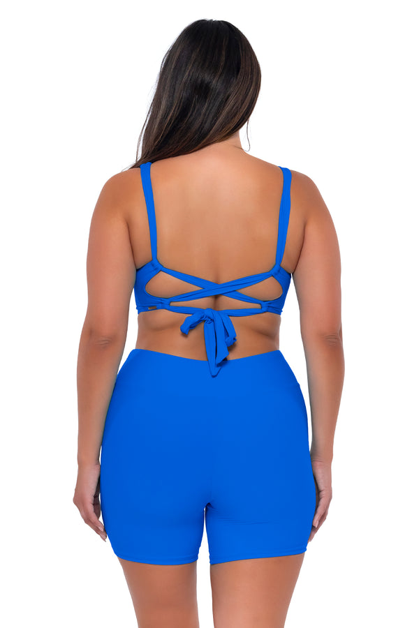 Back pose #1 of Nicky wearing Sunsets Escape Electric Blue Bayside Bike Short with matching Elsie Top underwire bikini