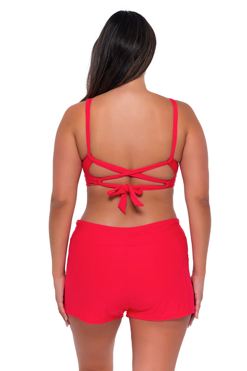 Back pose #1 of Nicky wearing Sunsets Escape Geranium Laguna Swim Short with matching Elsie Top underwire bikini