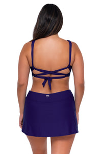 Back pose #1 of Nicky wearing Sunsets Indigo Elsie Top with matching Sporty Swim Skirt