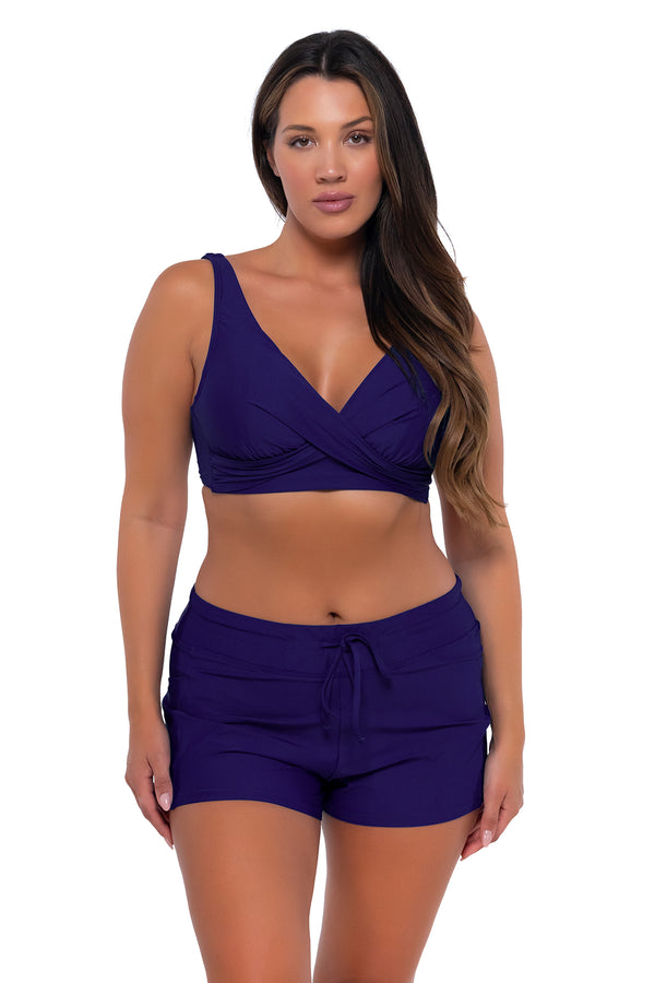 Front Front pose #1 of Nicky wearing Sunsets Escape Indigo Laguna Swim Short with matching Elsie Top underwire bikini