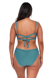 Back pose #1 of Nicky wearing Sunsets Ocean Unforgettable Bottom with matching Elsie Top underwire bikini