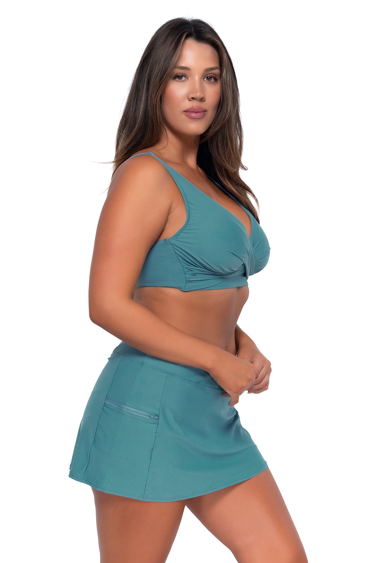 Side pose #1 of Nicky wearing Sunsets Ocean Sporty Swim Skirt with matching Elsie Top underwire bikini