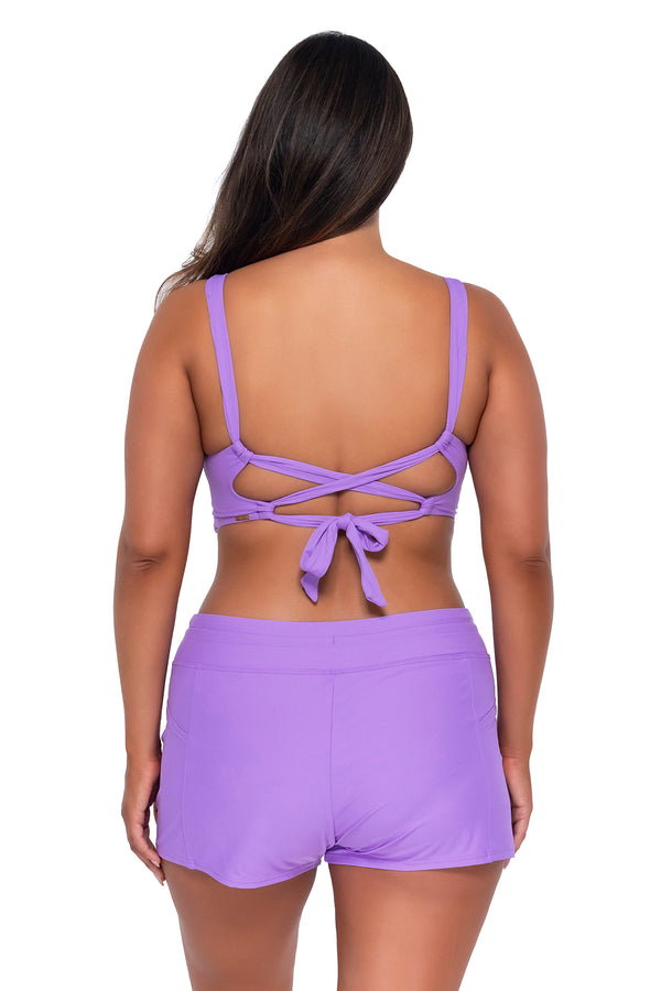 Back pose #1 of Nicky wearing Sunsets Escape Passion Flower Laguna Swim Short with matching Elsie Top underwire bikini