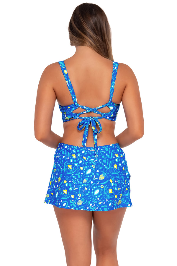 Back pose #1 of Taylor wearing Sunsets Pineapple Grove Sporty Swim Skirt with matching Elsie Top bikini bralette
