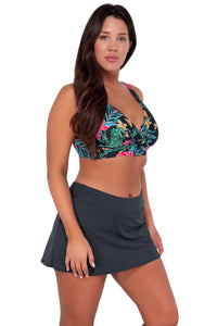 Side pose #1 of Nicki wearing Sunsets Twilight Blooms Elsie Top paired with Sporty Swim Skirt swim bottom
