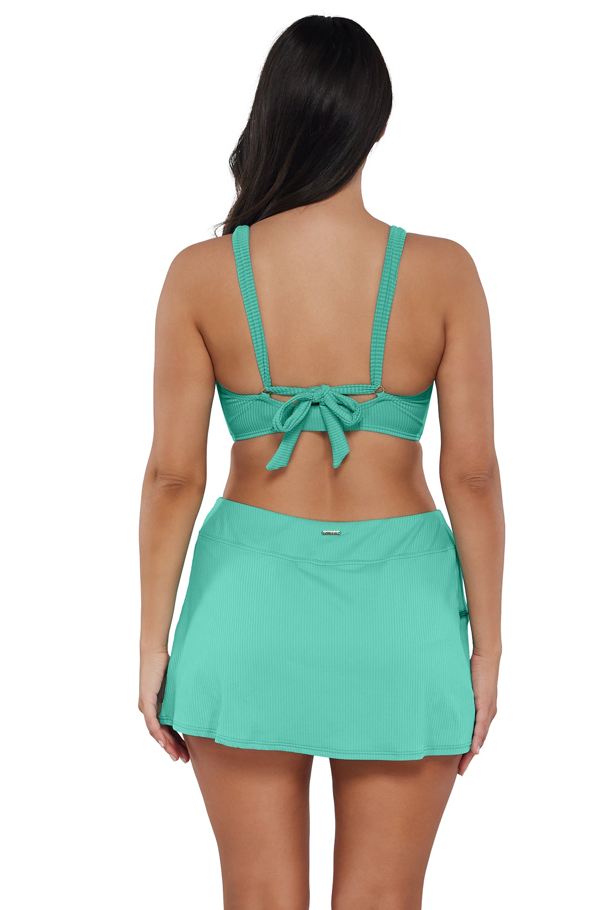 Back pose #1 of Nicki wearing Sunsets Aqua Mist Sandbar Rib Sporty Swim Skirt paired with matching