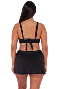 Back pose #1 of Nicki wearing Sunsets Black Seagrass Texture Vienna V-Wire Top paired with Sporty Swim Skirt swim bottom