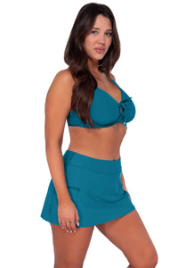 Side pose #1 of Nicki wearing Sunsets Avalon Teal Kauai Keyhole Top paired with Sporty Swim Skirt swim bottom