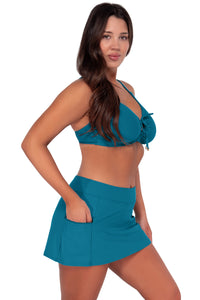 Side pose #1 of Nicki wearing Sunsets Avalon Teal Kauai Keyhole Top Sporty Swim Skirt swim bottom