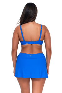 Back pose #1 of Nicky wearing Sunsets Electric Blue Sporty Swim Skirt with matching Kauai Keyhole bikini top