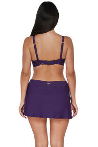 Back pose #1 of Nicki wearing Sunsets Paradise Plum Sporty Swim Skirt Bottom lifted to show attached swim short paired with matching Kauai Keyhole Bikini Top