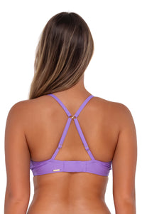 Back pose #1 of Taylor wearing Sunsets Passion Flower Kauai Keyhole Top showing crossback straps
