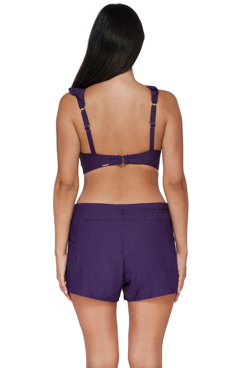 Back pose #1 of Nicki wearing Sunsets Escape Paradise Plum Laguna Swim Short Bottom