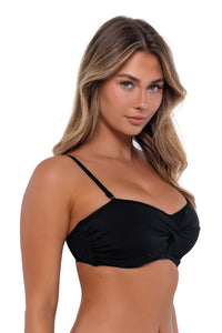 Side pose #1 of Taylor wearing Sunsets Black Iconic Twist Bandeau Top