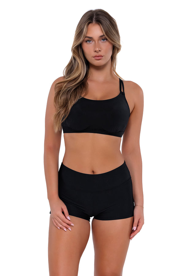Front pose #1 of Taylor wearing Sunsets Black Taylor Bralette Top with matching Kinsley Swim Short