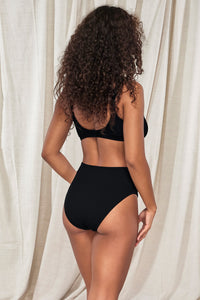 Oblique pose #1 of Jasmine wearing Pacifica Black Astrid High Waist Bottom paired with matching Oceana Bikini Top