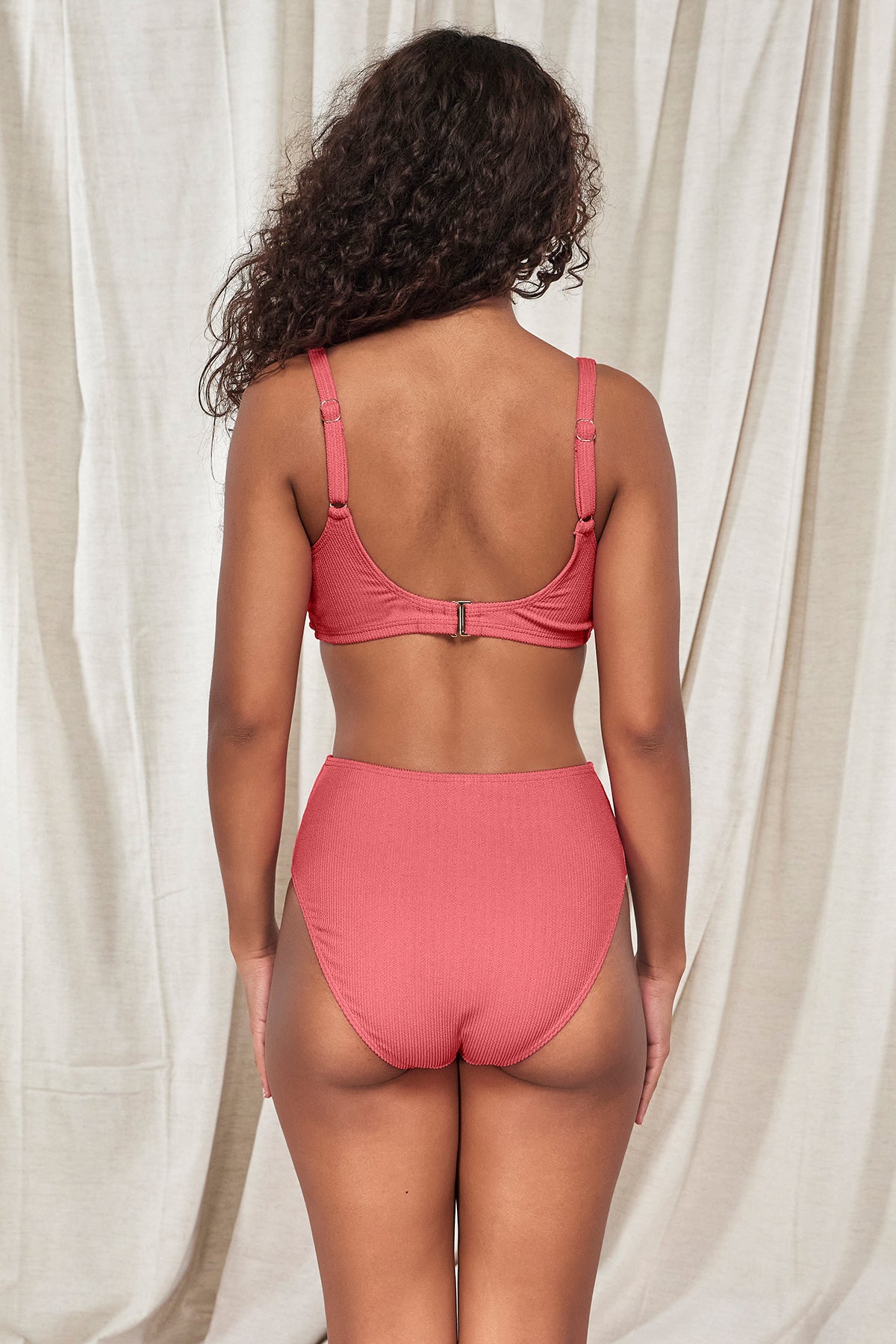 Back pose #1 of Jasmine wearing Pacifica Hibiscus Tea Oceana Top paired with matching Astrid High Waist Bottom