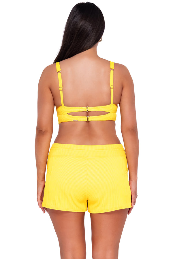 Back pose #1 of Nicki wearing Sunsets Escape Lemon Zest Sandbar Rib Laguna Swim Short Bottom with matching