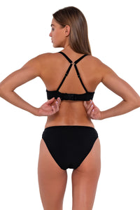 Back pose #1 of Daria wearing Sunsets Black Juliette Underwire Top showing hidden hook-and-eye closure with matching Kylie Hipster bikini bottom