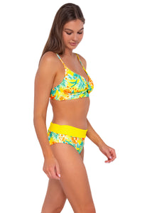 Side pose #1 of Daria wearing Sunsets Golden Tropics Sandbar Rib Capri High Waist Bottom showing folded waist with matching Lyla Bralette bikini top .