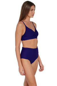 Quarter pose #1 of Daria wearing Sunsets Indigo Capri High Waist Bottom paired with matching Lyla Bralette Bikini Top