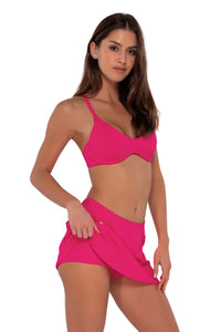 Side pose #1 of Gigi wearing Sunsets Begonia Sandbar Rib Sporty Swim Skirt paired with Brooke U-Wire bikini top