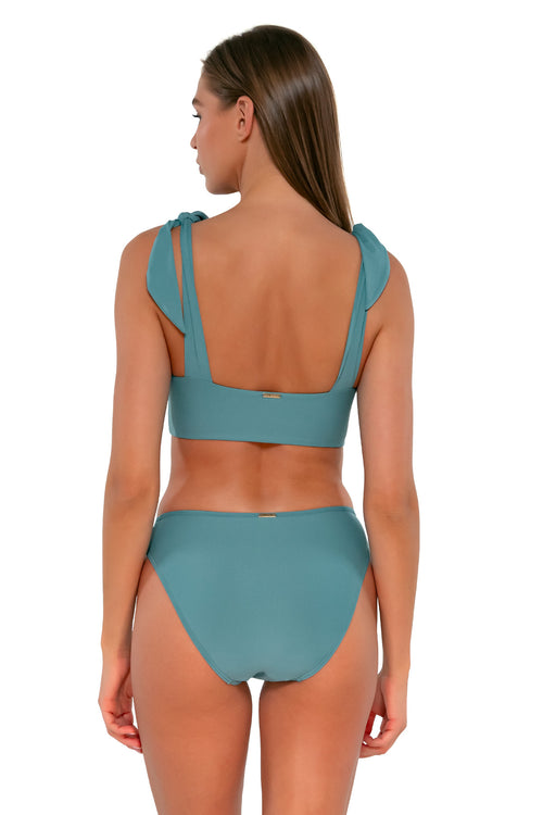 Back pose #1 of Daria wearing Sunsets Ocean Kylie Hipster Bottom with matching Lily Top bikini