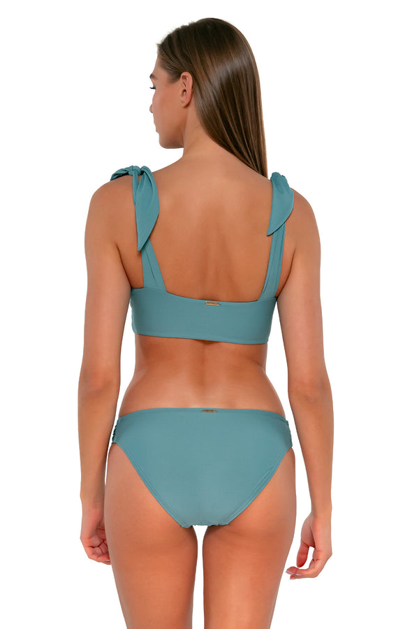 Back pose #1 of Daria wearing Sunsets Ocean Femme Fatale Hipster Bottom with matching Lily Top bikini