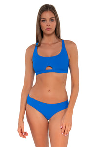 Front pose #1 of Daria wearing Sunsets Electric Blue Brandi Bralette Top with matching Alana Reversible Hipster bikini bottom