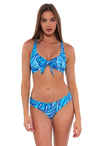 Front pose #1 of Daria wearing Sunsets Seaside Vista Brandi Bralette Top showing bralette front tie with matching Alana Reversible Hipster bikini bottom
